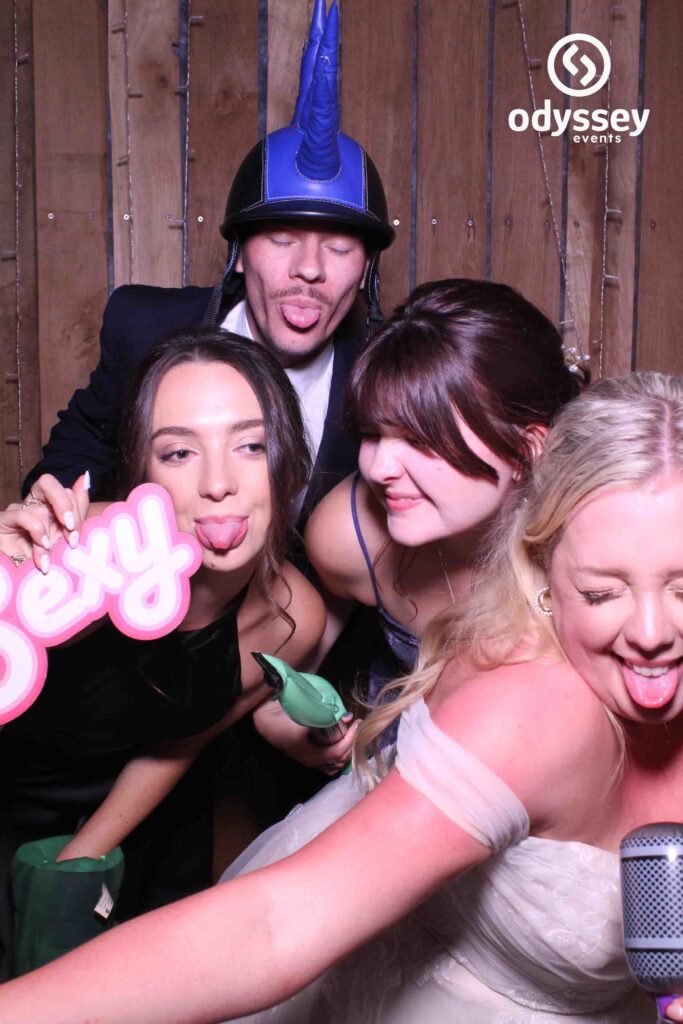 Guests laughing with props at Sophie & George’s Chafford Park wedding photobooth in Tunbridge Wells