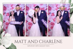 Matt and Charlène at their wedding in The Spa Hotel, Tunbridge Wells, with joyful guests in the background.