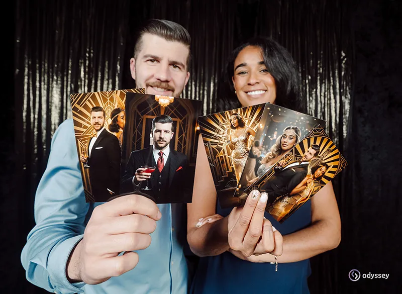 Two guests holding personalised AI-generated portrait prints created at an Odyssey Events experience