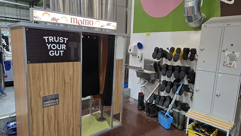 Bespoke wooden photo booth with MOMO Kombucha branding and Trust Your Gut signage at a company launch