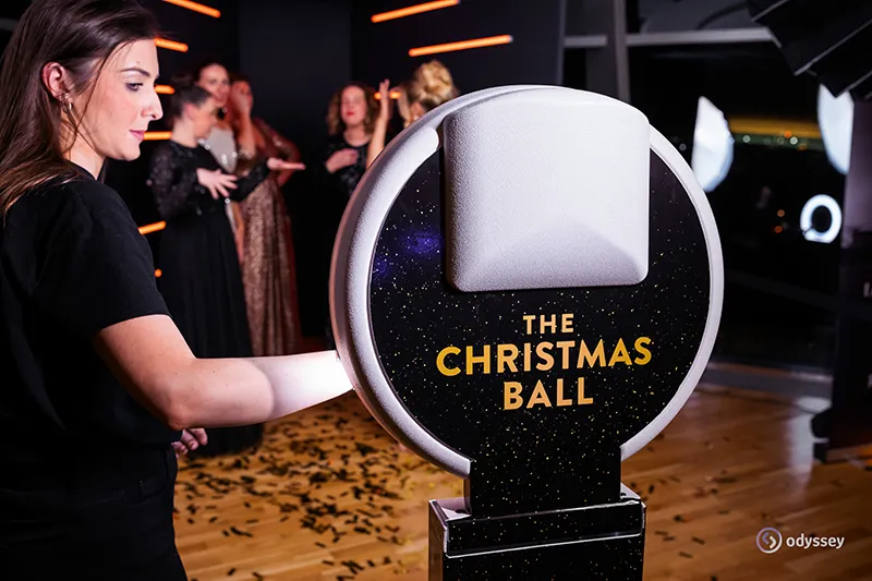 Guest interacting with a photobooth at a Christmas ball